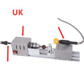 Silver metal mini manual woodworking lathe with carving knives on a bench
