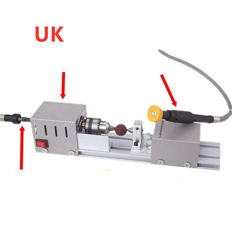 Silver metal mini manual woodworking lathe with carving knives on a bench