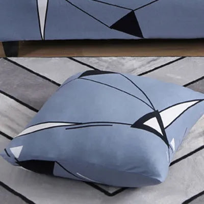 Geometric patterned stretch sofa slipcover fitted on a three-seater sofa in a living room.