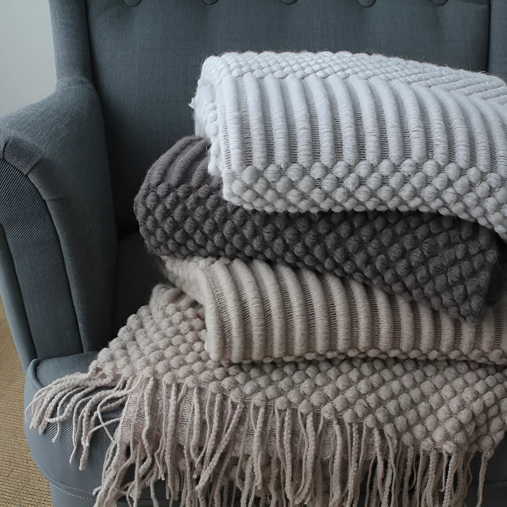Small grey polyester blanket folded, dimensions 127 by 170 centimetres.