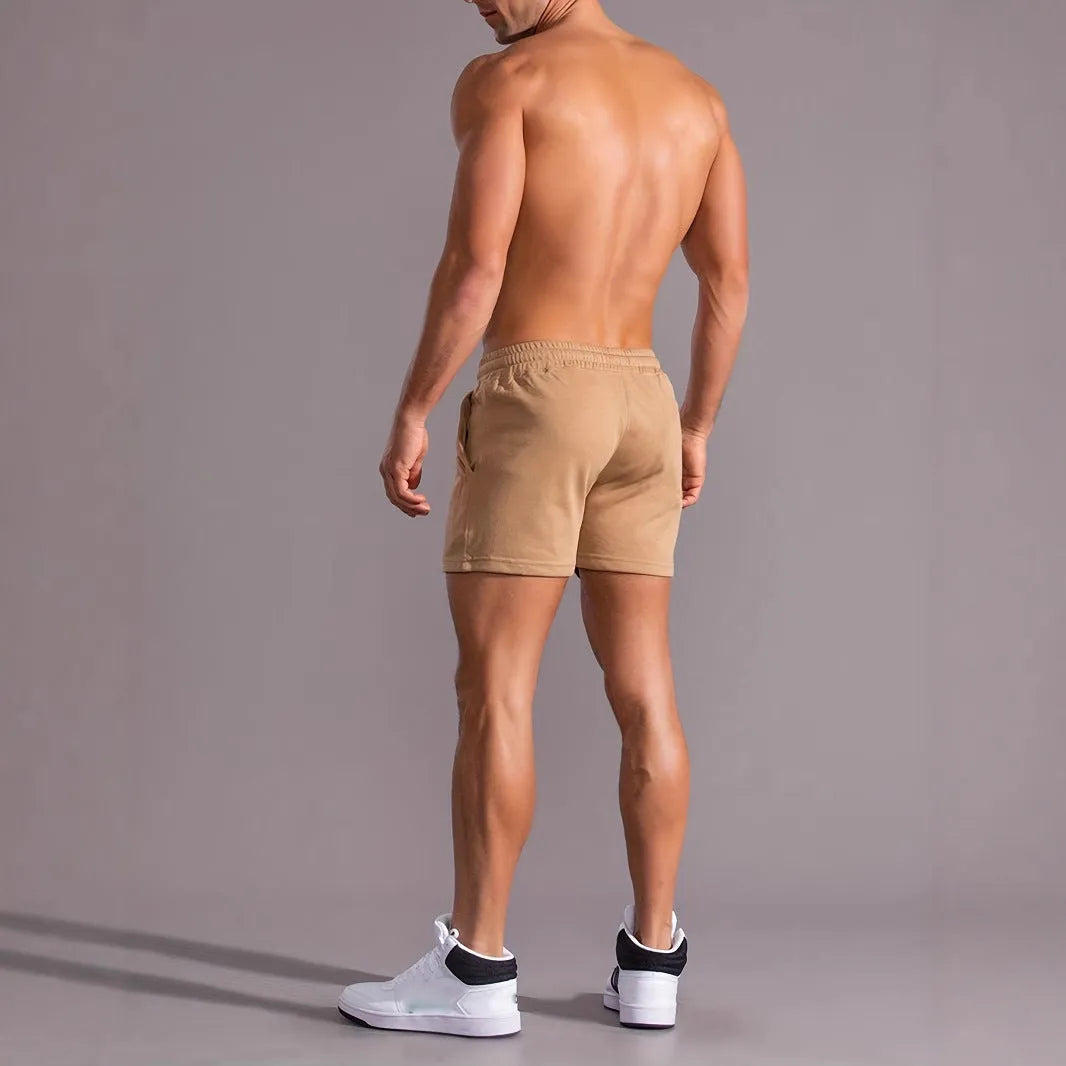 A pair of khaki men's casual shorts featuring a coconut print, shown in a straight-leg sports style.