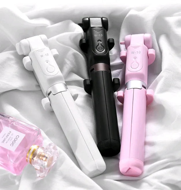 Black Bluetooth selfie stick with tripod bracket extended showing phone clamp and remote control
