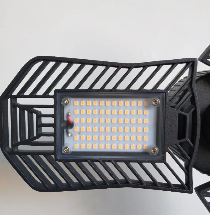 Foldable silver die-cast aluminium industrial LED lamp with a wide-angle lens for garage lighting.