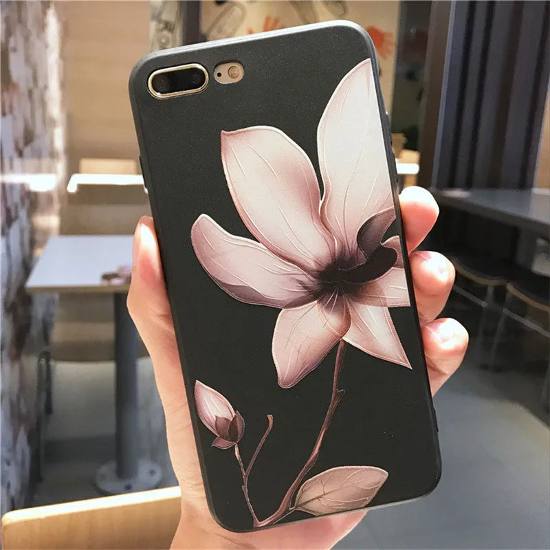 Black TPU iPhone case with a white raised embossed floral pattern on the back.