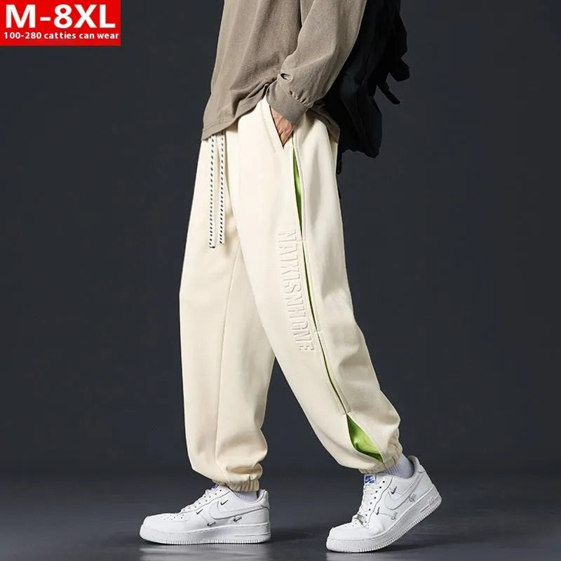Men's loose fit cotton trousers with banded ankle and collage stitching detail in grey green