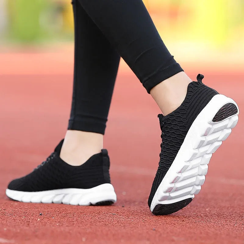Women's running shoes in black, pink, or white with fly weaving upper and wear-resistant outsole