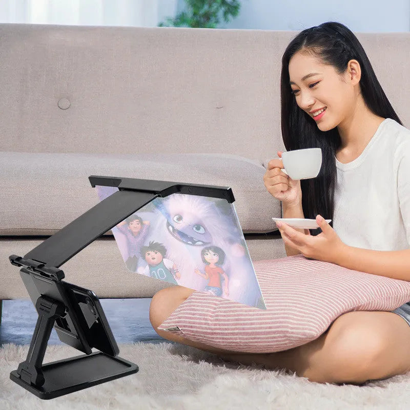 Black L20 split mobile phone screen magnifier with acrylic lens on a table next to its mounting bracket.