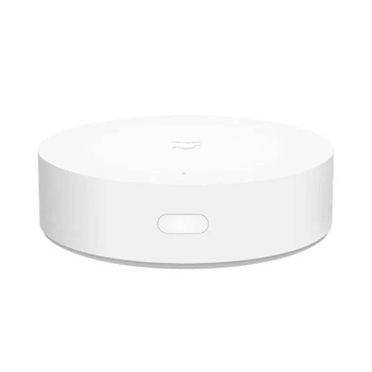White circular Xiaomi Mijia smart home gateway with UK plug for wireless device control