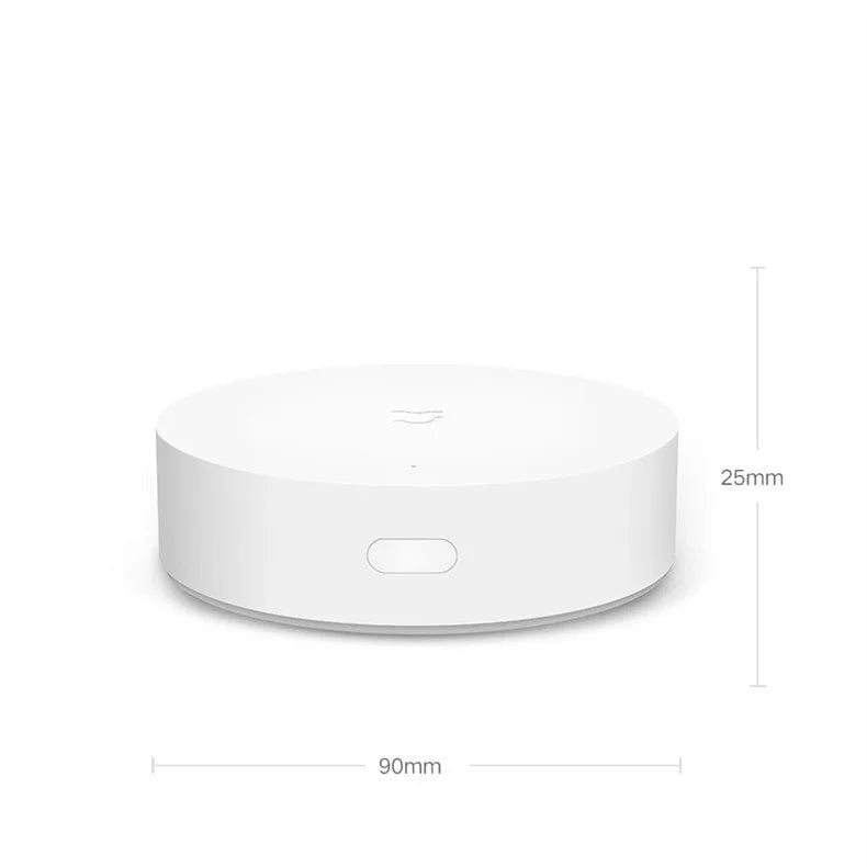 White circular Xiaomi Mijia smart home gateway with UK plug for wireless device control