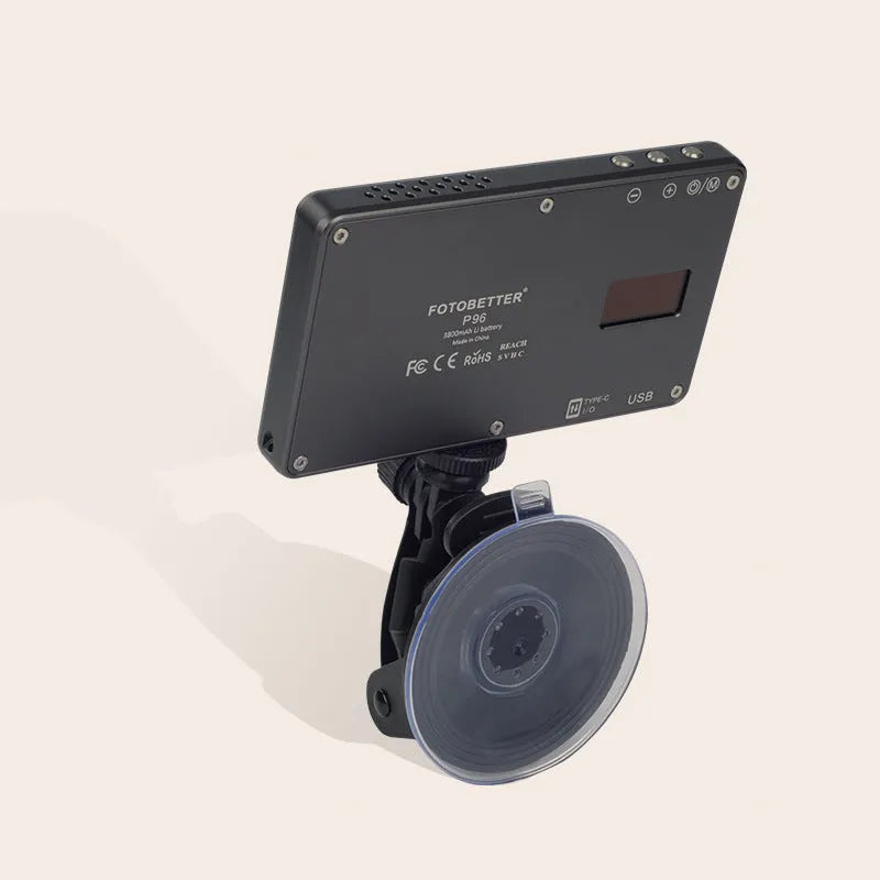 Black aluminium USB LED video conference light with LCD screen, shown next to a laptop