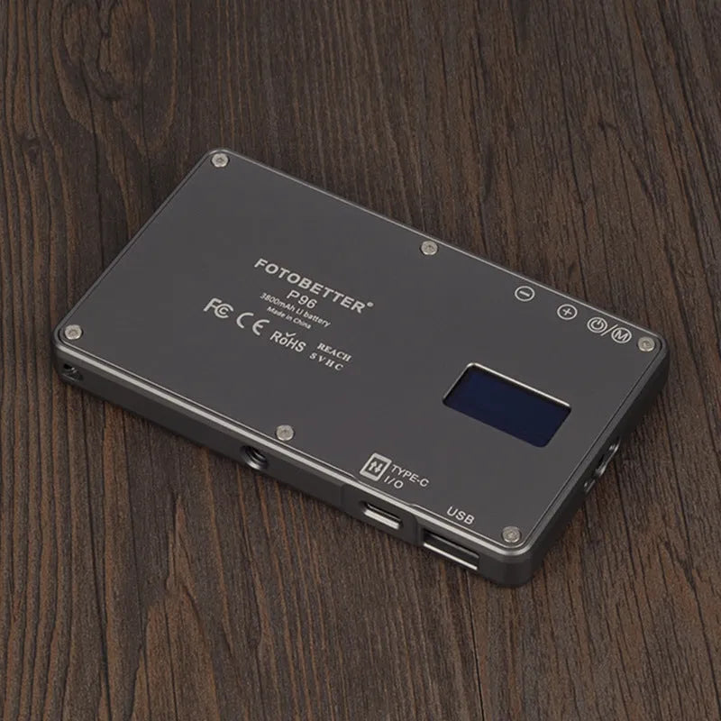 Black aluminium USB LED video conference light with LCD screen, shown next to a laptop