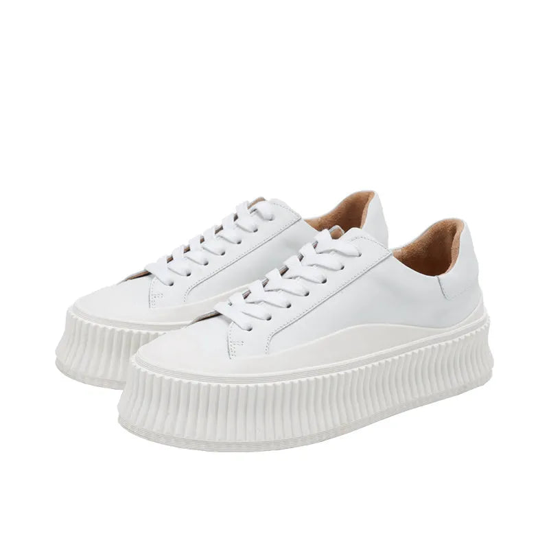 Women's white suede sneakers with thick platform sole and cross-binding lace detail