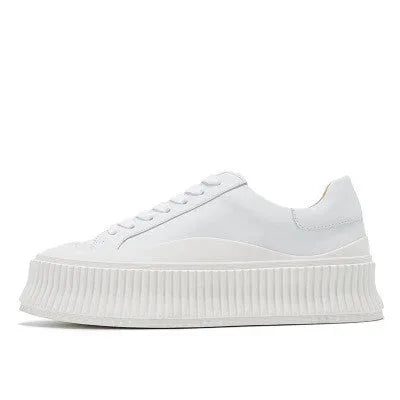 Women's white suede sneakers with thick platform sole and cross-binding lace detail