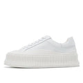 Women's white suede sneakers with thick platform sole and cross-binding lace detail