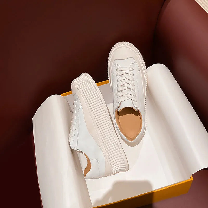 Women's white suede sneakers with thick platform sole and cross-binding lace detail