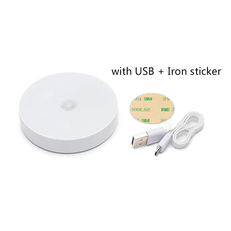 White circular motion sensing night light with USB charging port mounted on wall