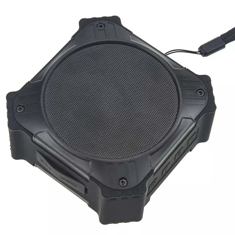 Small black waterproof portable Bluetooth speaker with a wrist strap lanyard.