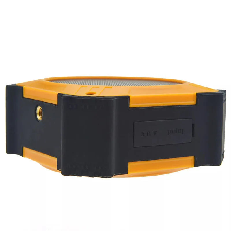 Small black waterproof portable Bluetooth speaker with a wrist strap lanyard.