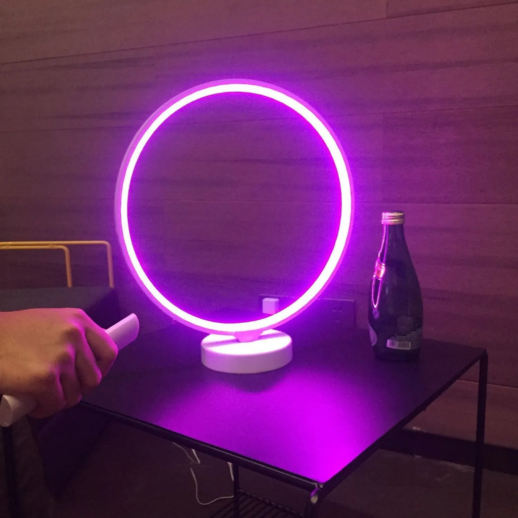 White aluminium and silicone full moon mood lamp with remote control on a table.