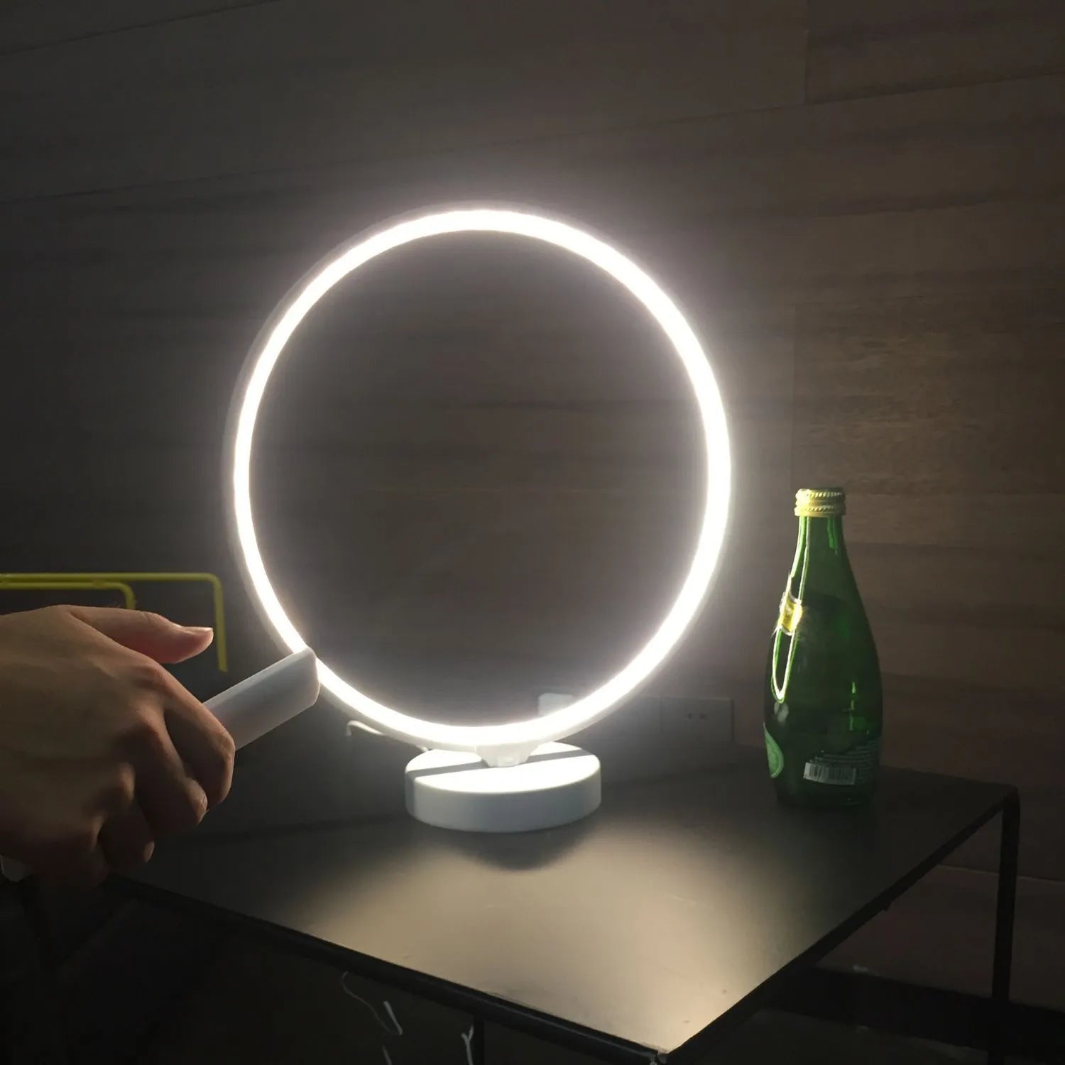 White aluminium and silicone full moon mood lamp with remote control on a table.
