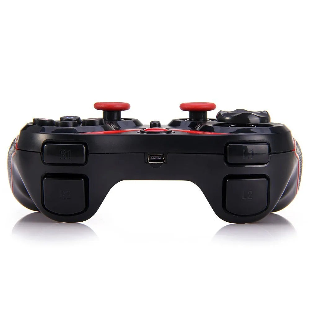 Black wireless Bluetooth gamepad controller for mobile phones on a table next to a charging cable.