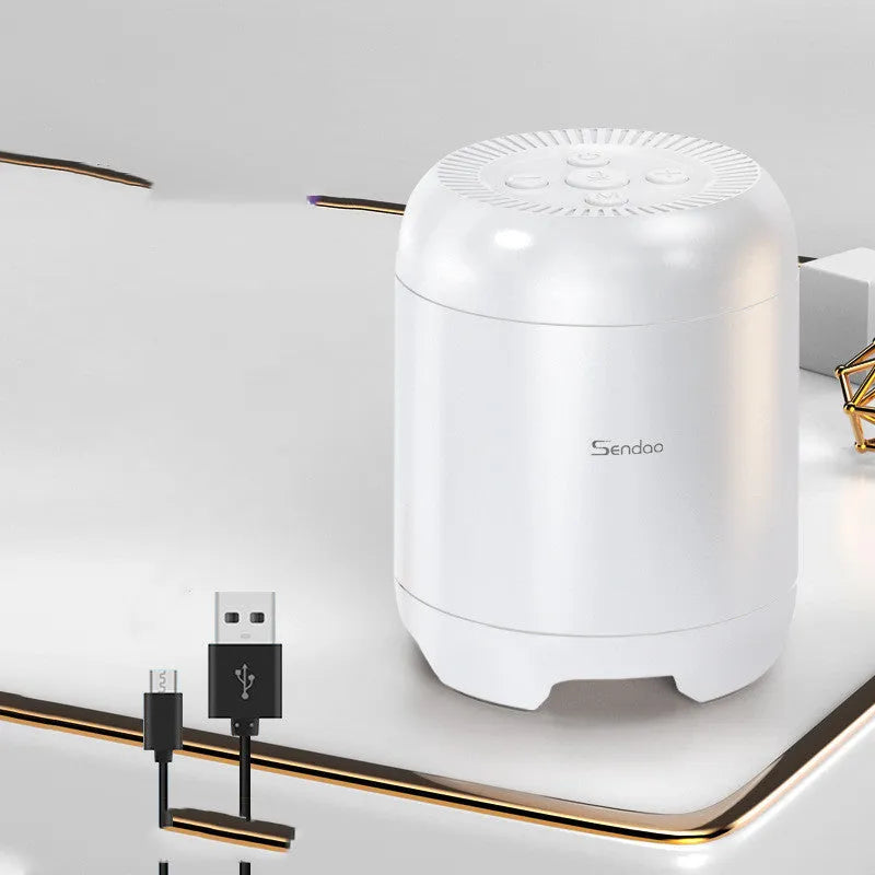 Small black or white wireless Bluetooth speaker with super subwoofer on a desk.