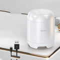Small black or white wireless Bluetooth speaker with super subwoofer on a desk.