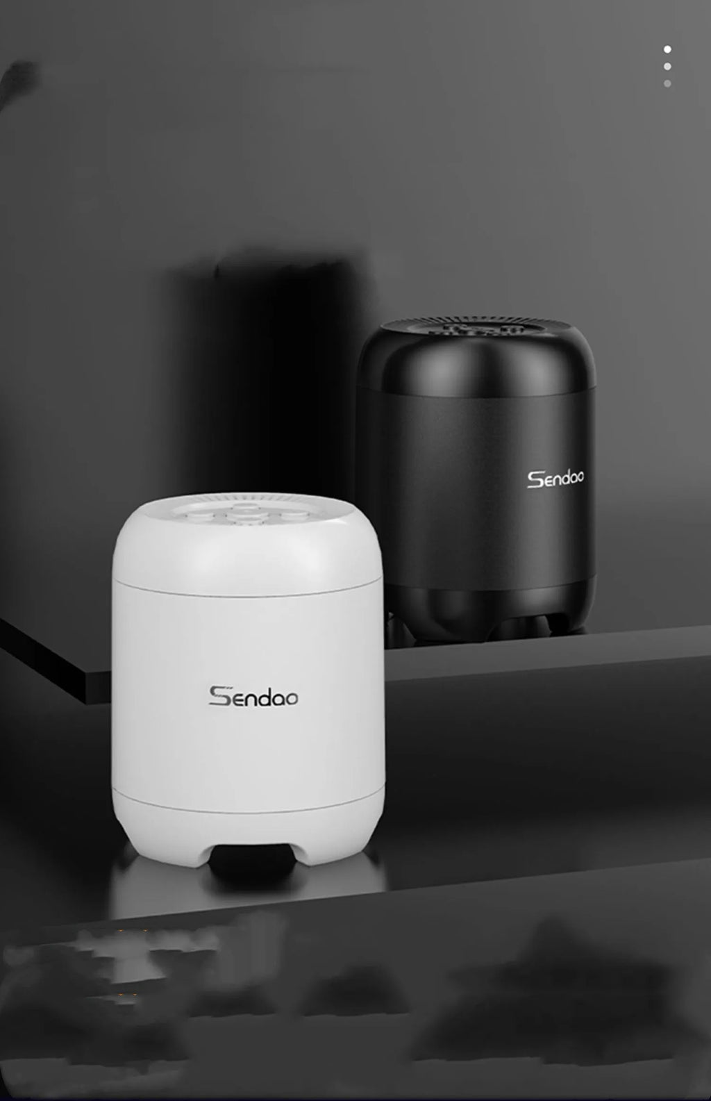 Small black or white wireless Bluetooth speaker with super subwoofer on a desk.