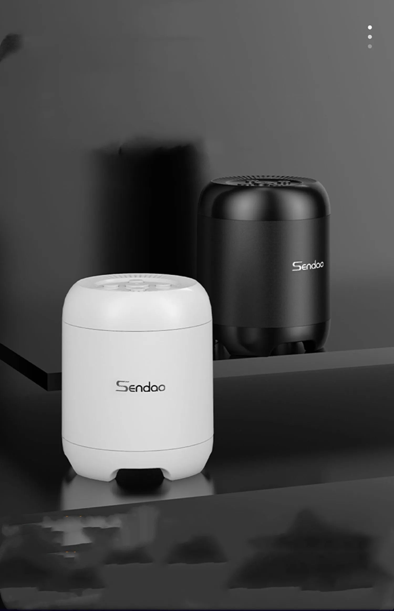 Small black or white wireless Bluetooth speaker with super subwoofer on a desk.
