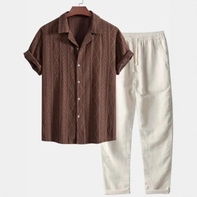 Men's slim fit camouflage print casual suit with short sleeve shirt and trousers on a hanger.