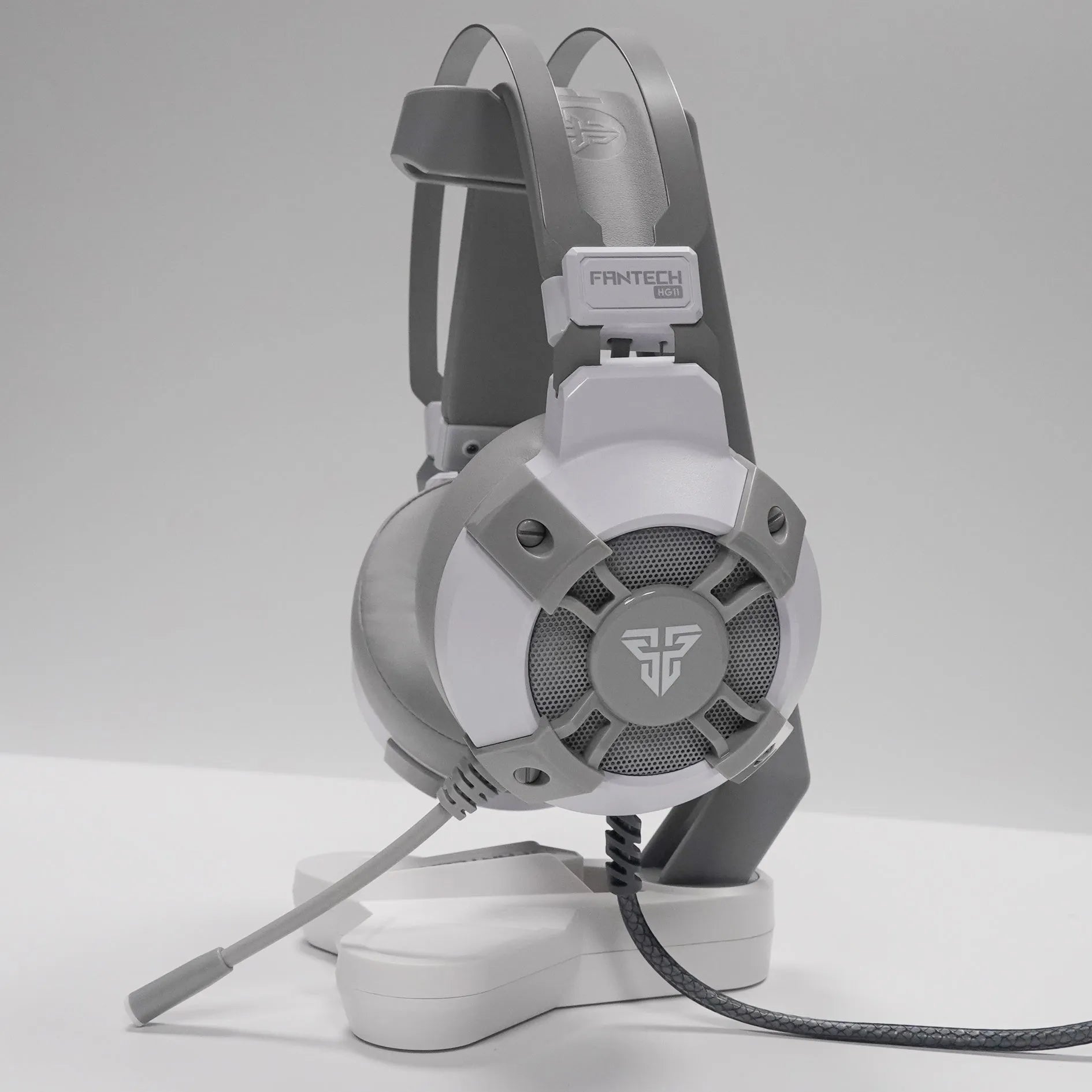 Black FANTECH HG11 gaming headset with RGB lights, large ear cups, and a noise-cancelling microphone on a flexible boom.
