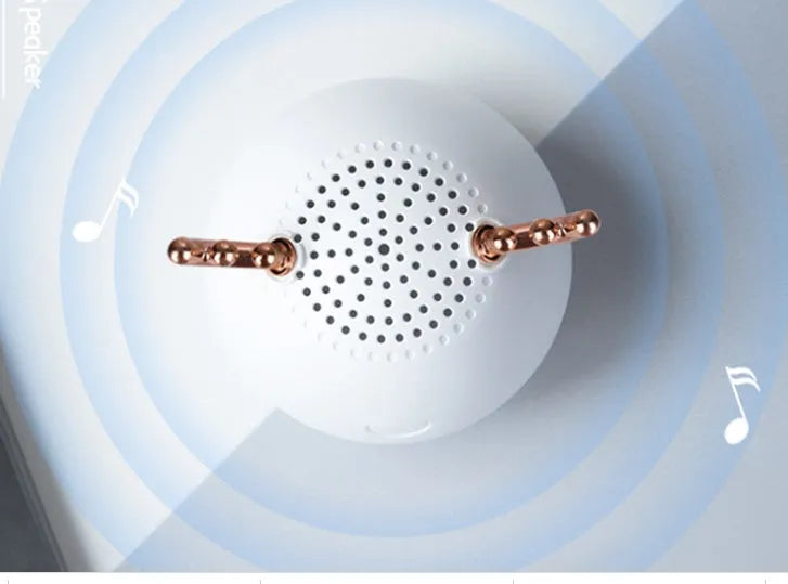 Small portable Bluetooth speaker in white pink or green colours with USB charging port