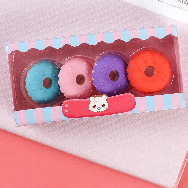 Set of 12 colourful cartoon food erasers including ice cream cones, donuts, and lollipops.