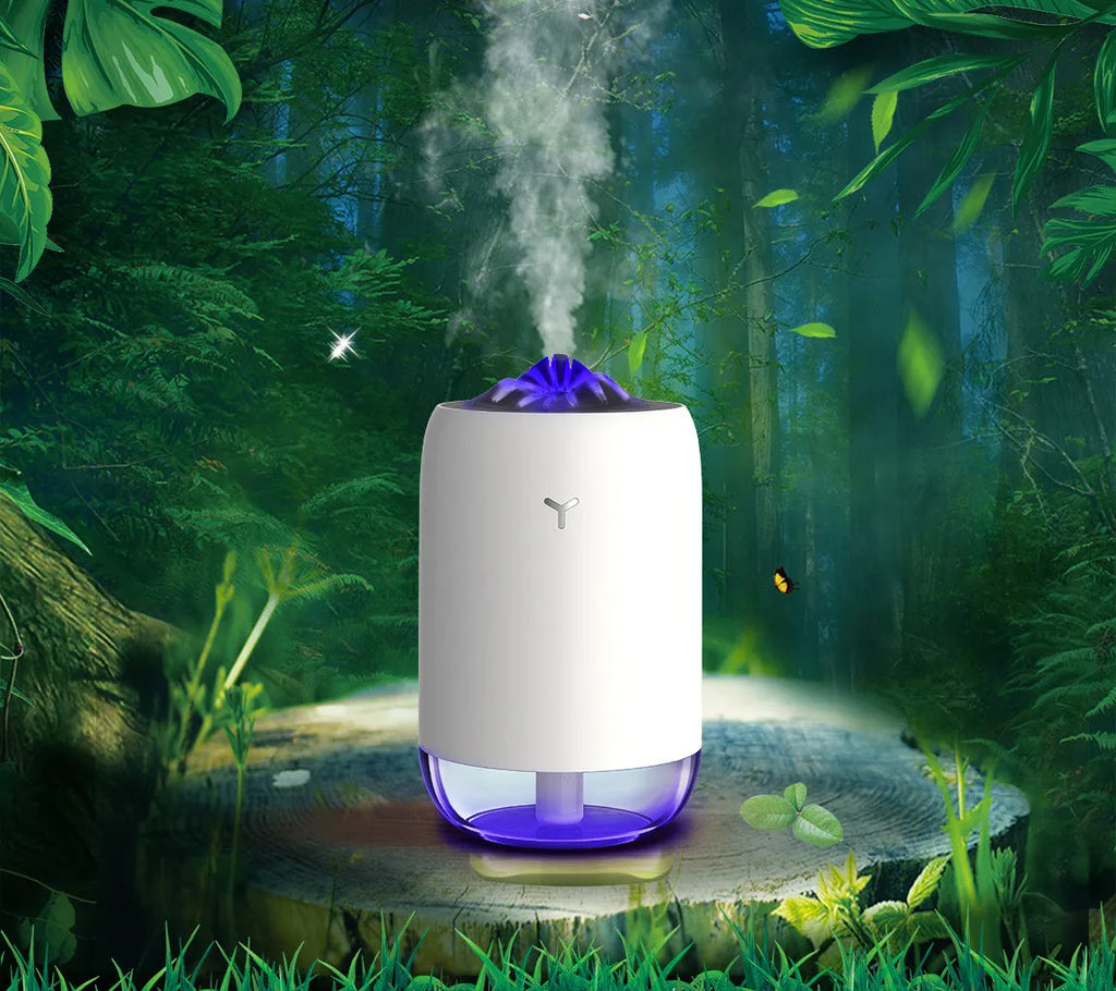 White columnar Magic Flame ultrasonic humidifier with USB cable and water tank on a wooden desk.