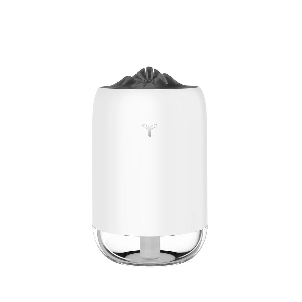 White columnar Magic Flame ultrasonic humidifier with USB cable and water tank on a wooden desk.