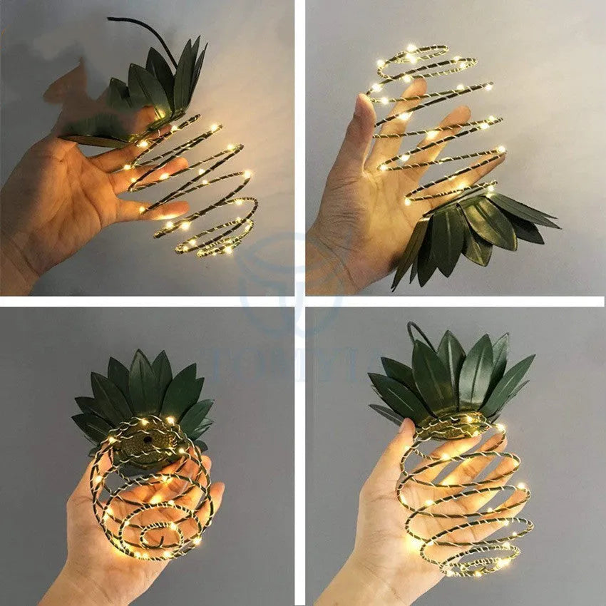 Outdoor waterproof green pineapple solar path light with 20 warm white LEDs and metal frame on a garden table