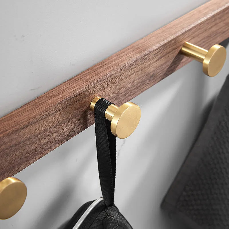 Black walnut aluminium bathroom clothes hooks with brass wire drawing accents on perforated mounting plate