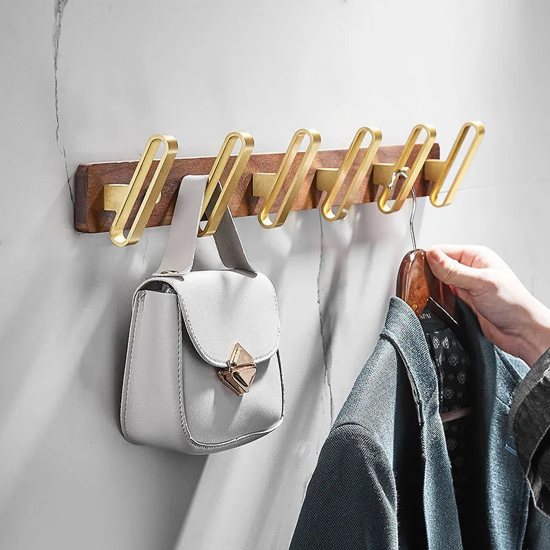 Black walnut aluminium bathroom clothes hooks with brass wire drawing accents on perforated mounting plate