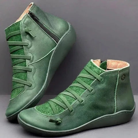 Women's black casual flat ankle boots with a round toe and wedge heel on a rubber sole.