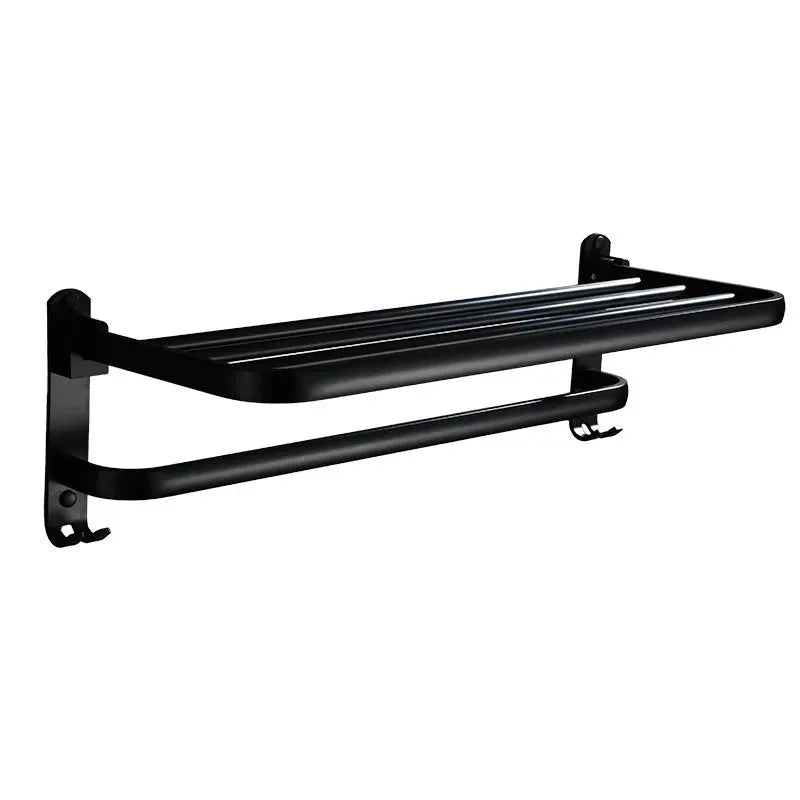 Silver aluminium double-layer folding towel rack with perforated shelf mounted on a bathroom wall.