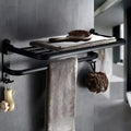 Silver aluminium double-layer folding towel rack with perforated shelf mounted on a bathroom wall.