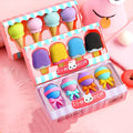 Set of 12 colourful cartoon food erasers including ice cream cones, donuts, and lollipops.