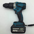 21V black and orange cordless impact drill with lithium battery pack on a workbench.