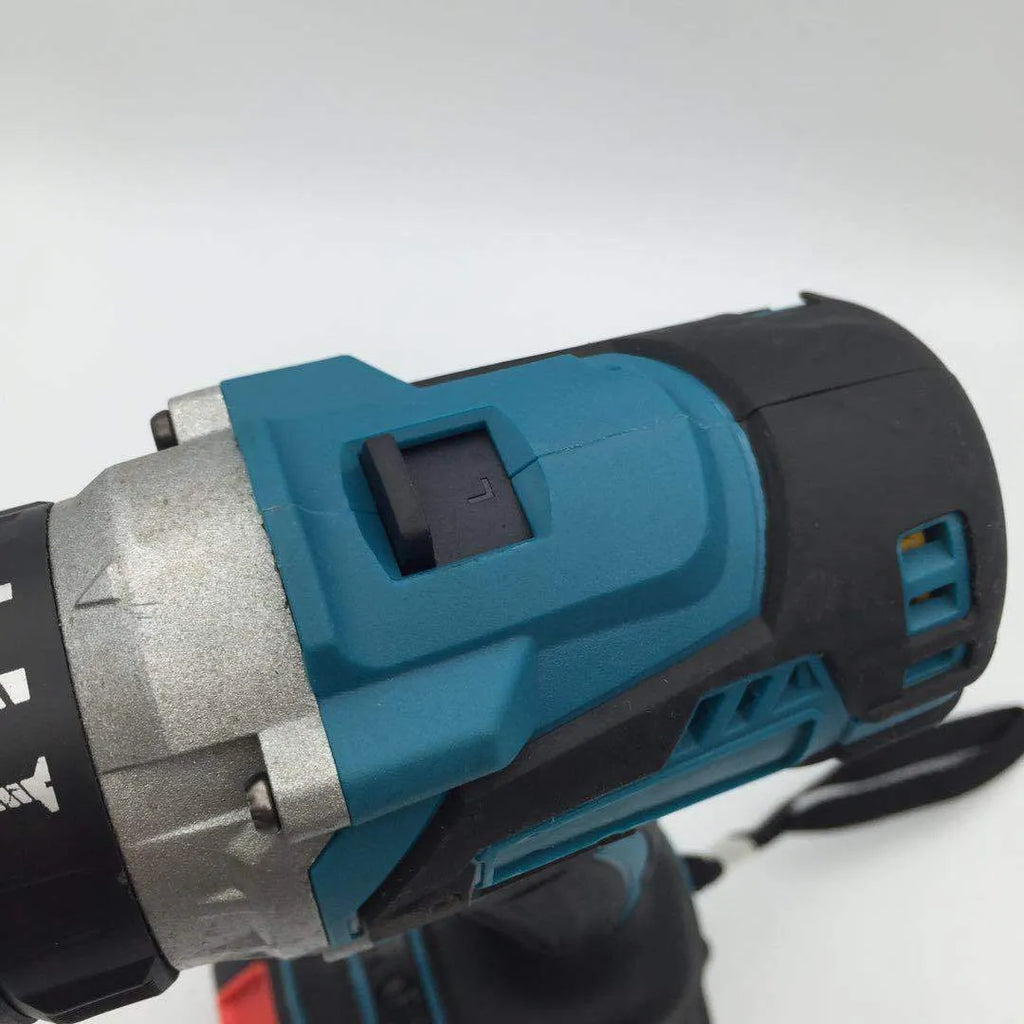 21V black and orange cordless impact drill with lithium battery pack on a workbench.