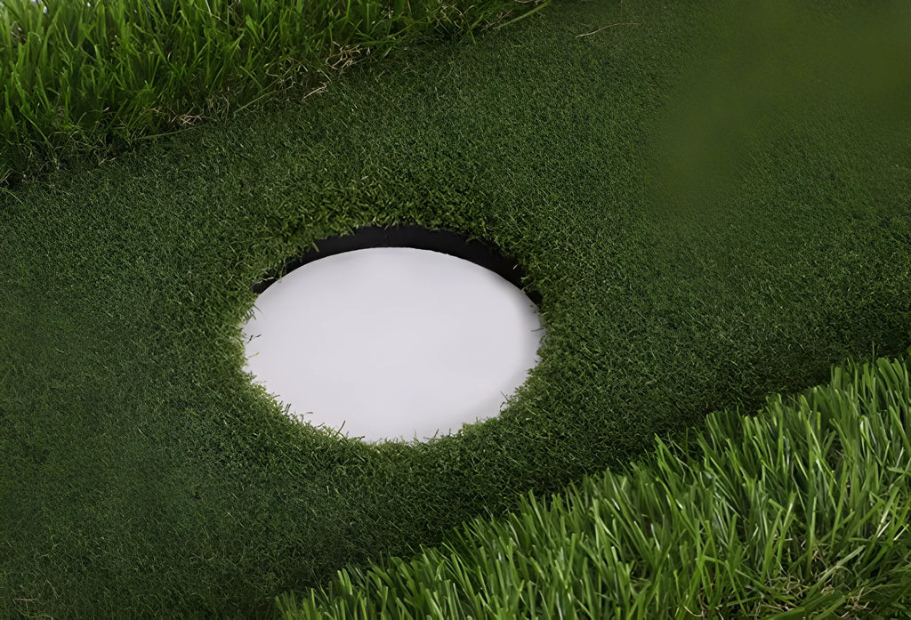 Green rectangular golf practice mat with a textured grass-like surface on a cushioned base.