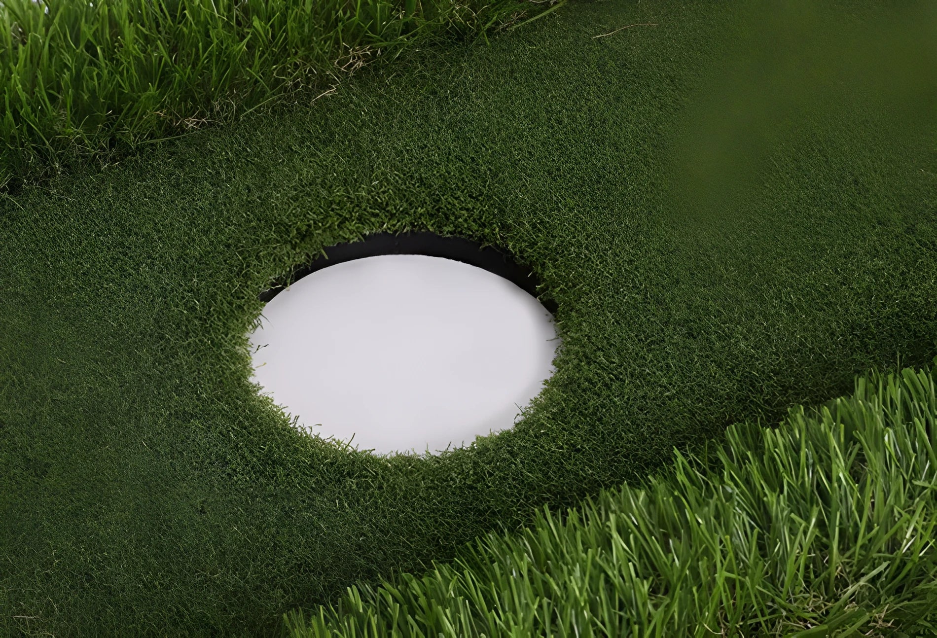 Green rectangular golf practice mat with a textured grass-like surface on a cushioned base.