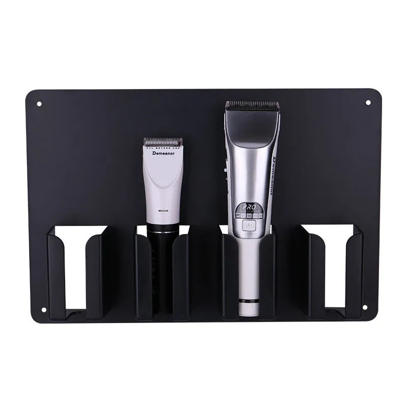 Black plastic wall-mounted rack holding four electric hair clippers for salon or home storage