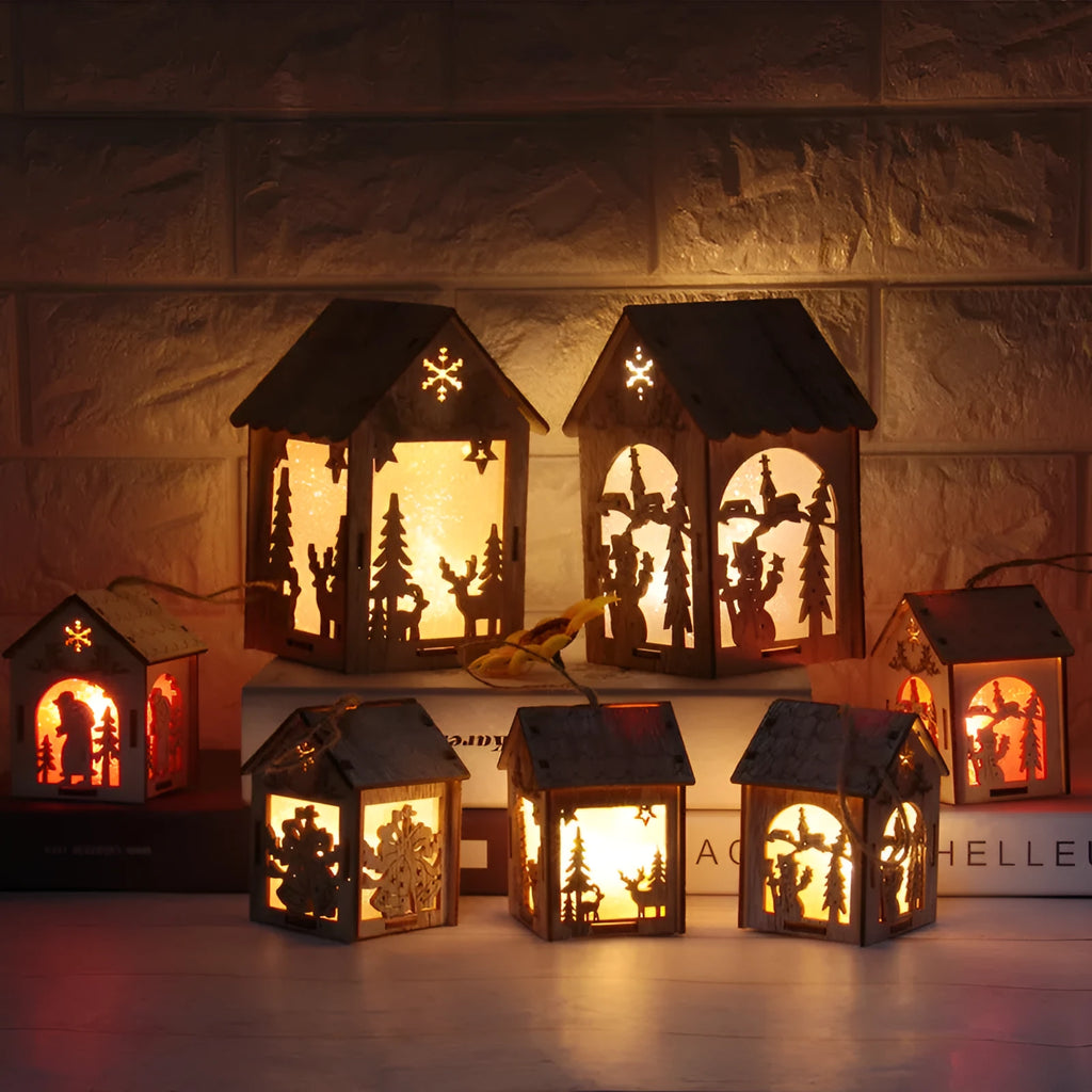 Three wooden Christmas decorations: small log bell, wooden house Santa, and wooden house snowman in natural wood colour