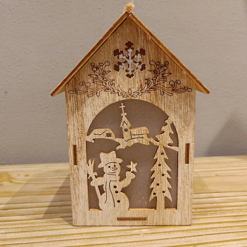 Three wooden Christmas decorations: small log bell, wooden house Santa, and wooden house snowman in natural wood colour