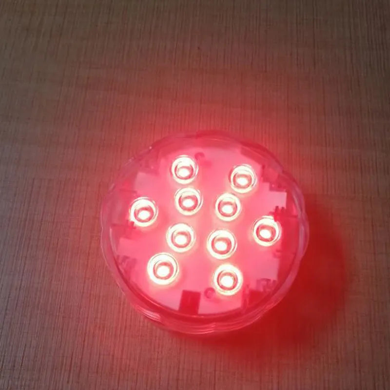 White waterproof LED pool light with remote control on a table